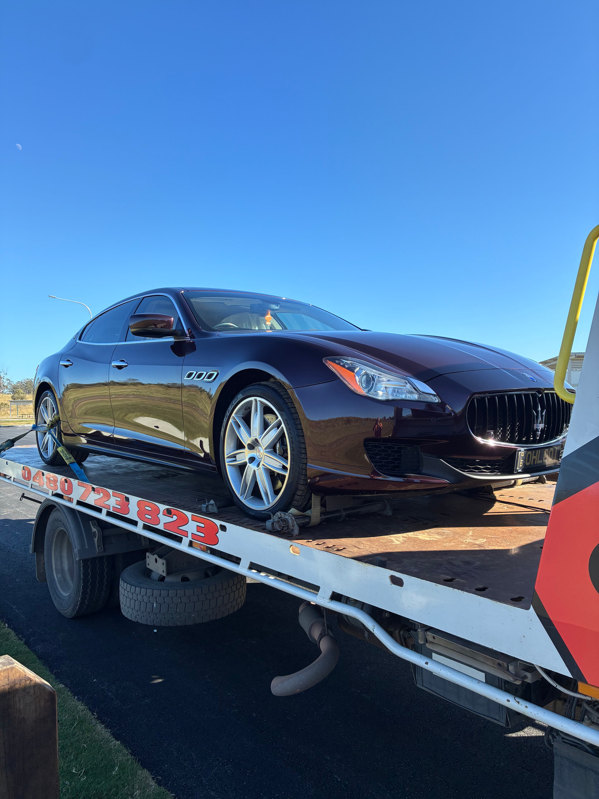 Broken down Maserati on the back of our tilt tray