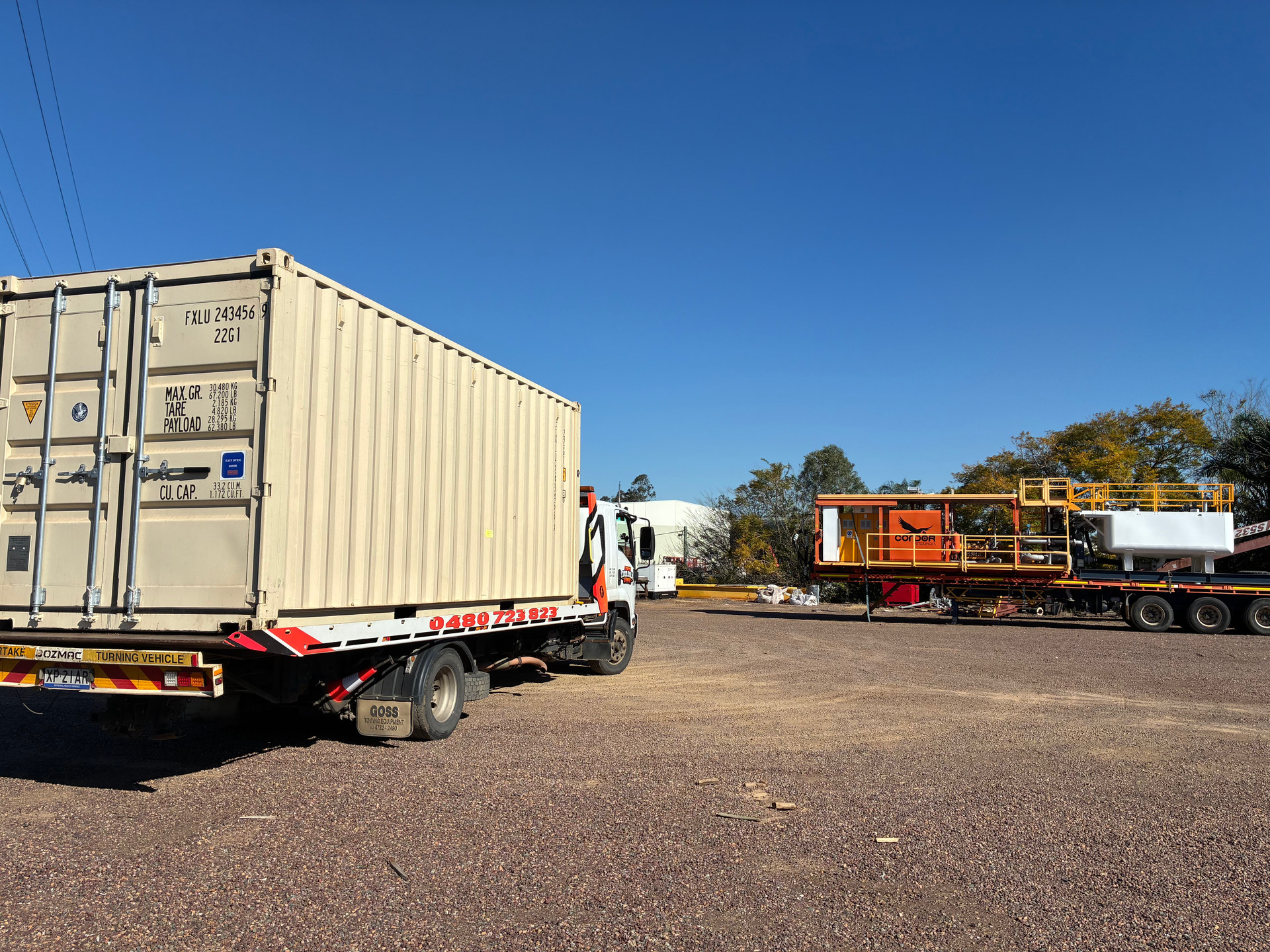Shipping container being transported on one of our tilt tray tow trucks