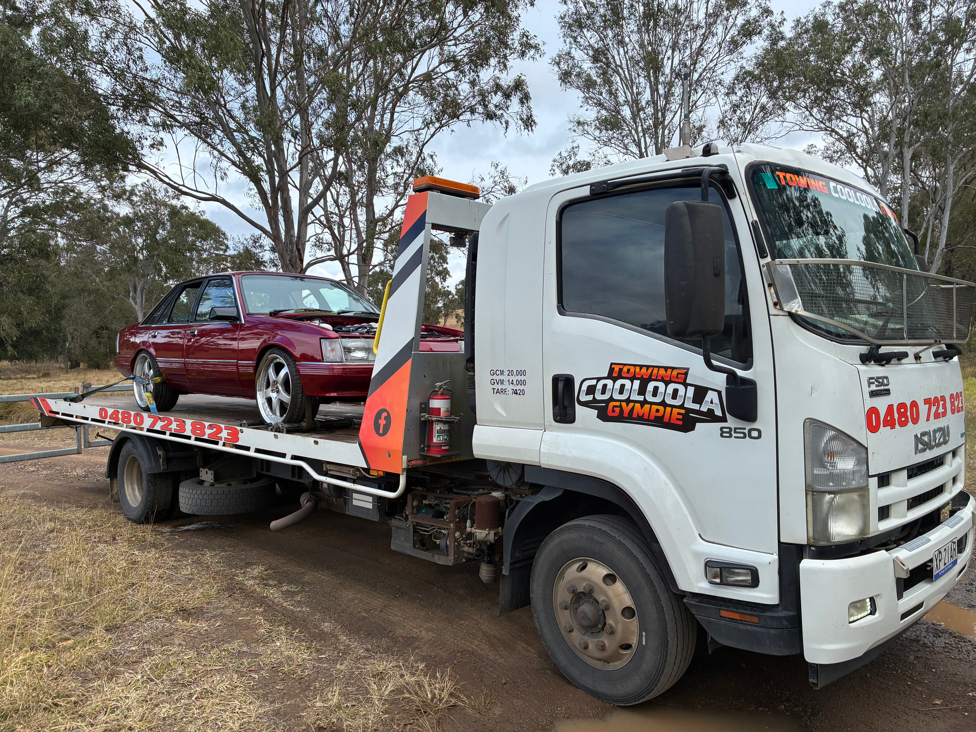 Red ute on the back of our tilt tray truck